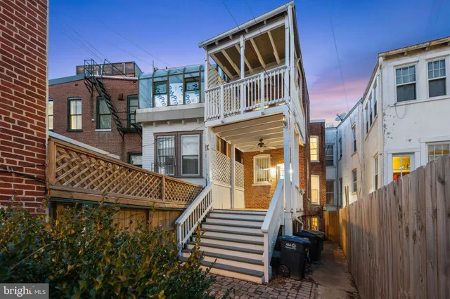a front view of a residential apartment building with a yard