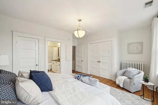 a bedroom with furniture and a chandelier