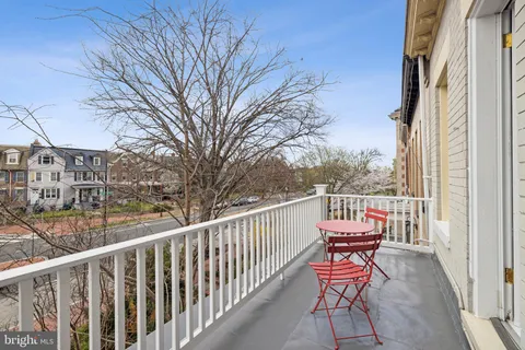 a view of a two chairs in the balcony
