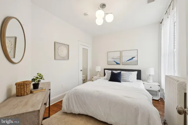 a bedroom with a large bed and a chandelier