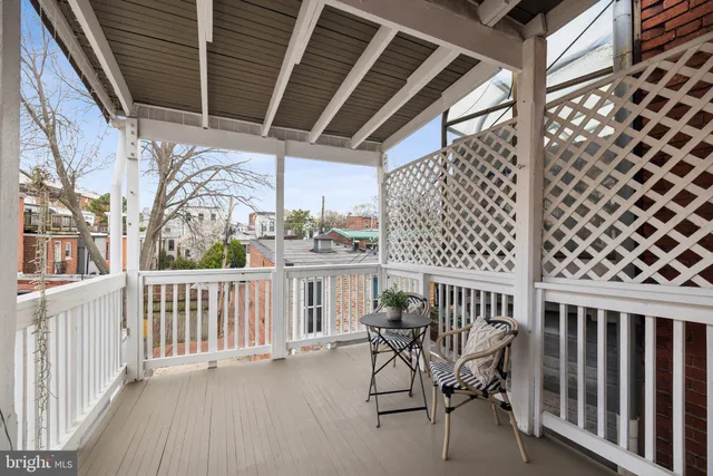 a view of a chair and table in the balcony