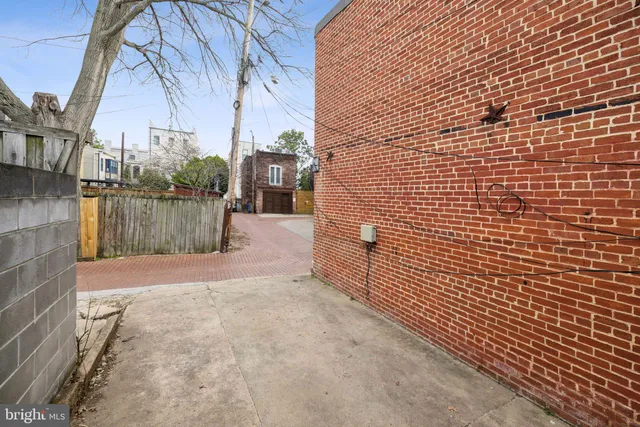 a view of a pathway both side of house