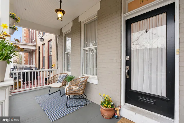 a porch with furniture and flowers