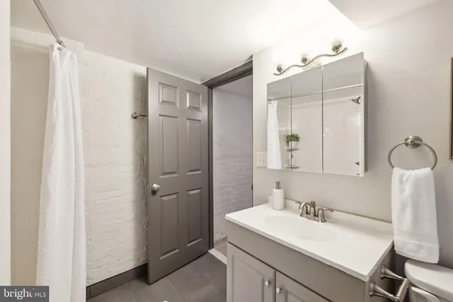 a bathroom with a sink vanity tub and shower