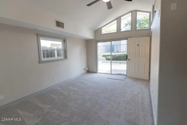 an empty room with windows lake and mountain view