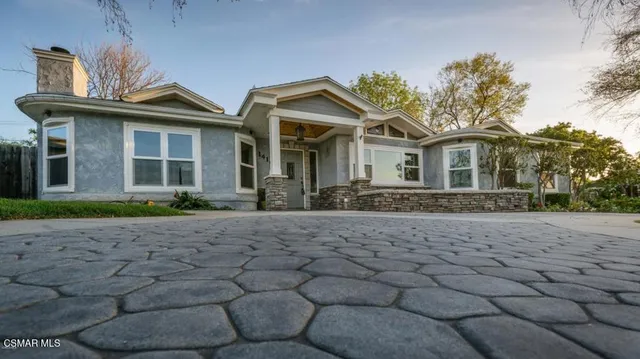 a view of a brick house with a large windows