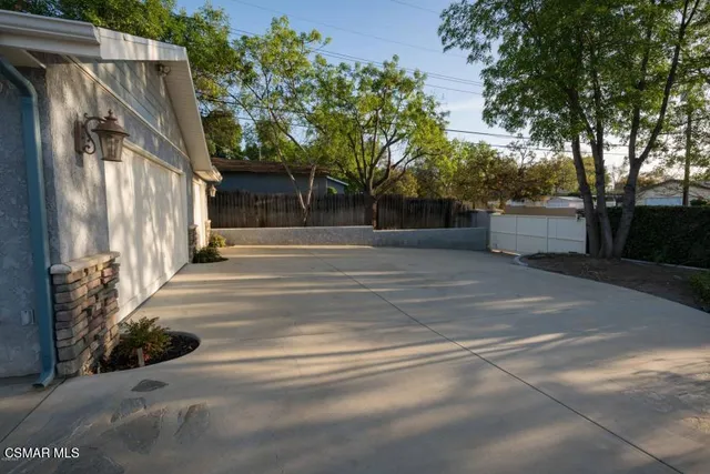 a view of a house with a tree in front