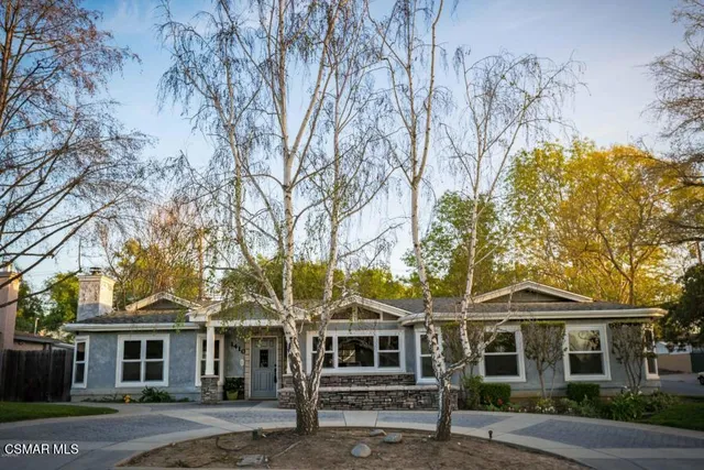 front view of a house with a tree