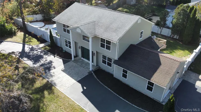 an aerial view of house with yard
