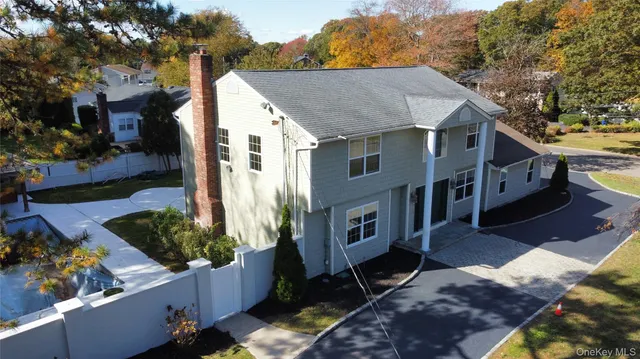 a aerial view of a house with a yard and potted plants
