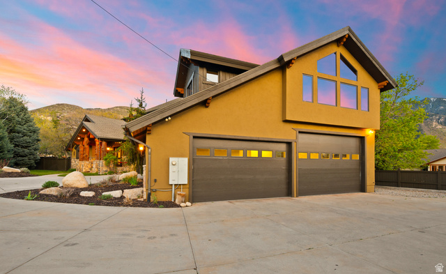 10280 Dimple Dell Road Sandy, UT 84092 - Photo 4 of 58 View of front facade with concrete driveway, stucco siding, a mountain view, and a garage