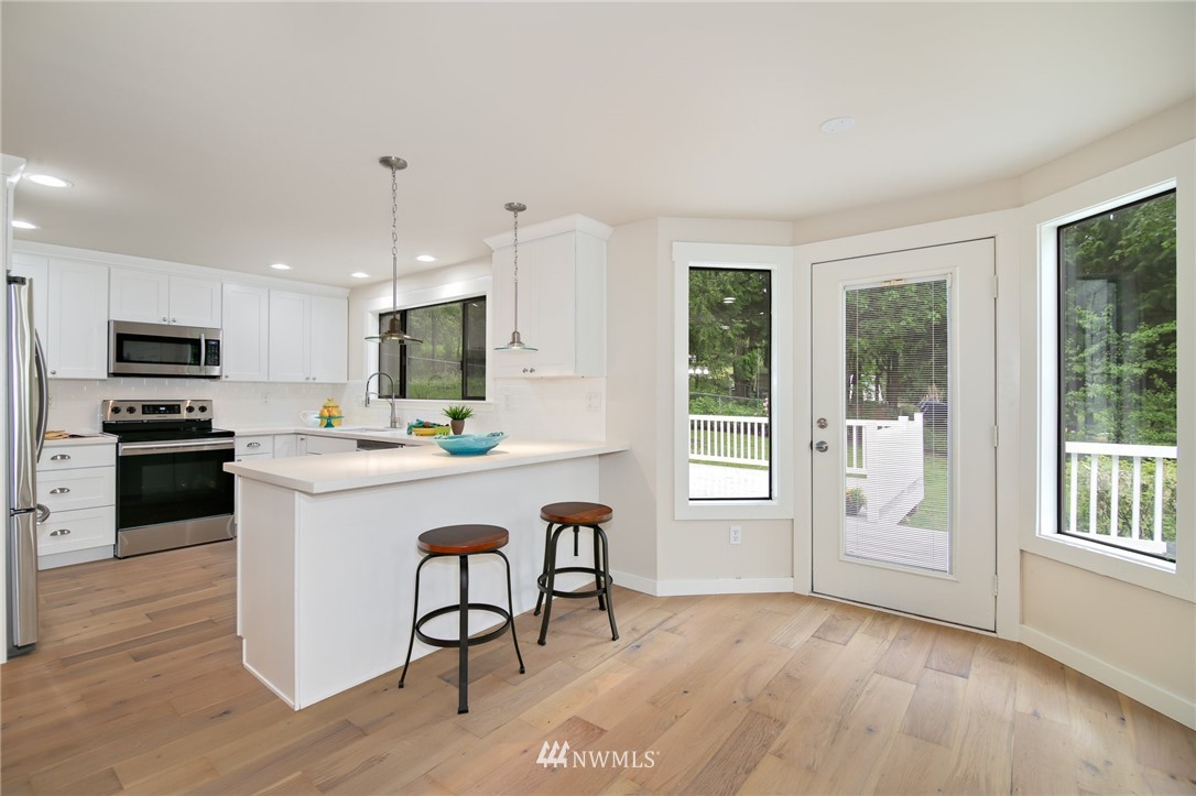 28505 Northeast Tolt Hill Road Carnation, WA 98014 - Photo 12 of 25 a kitchen with granite countertop a stove a sink and a refrigerator