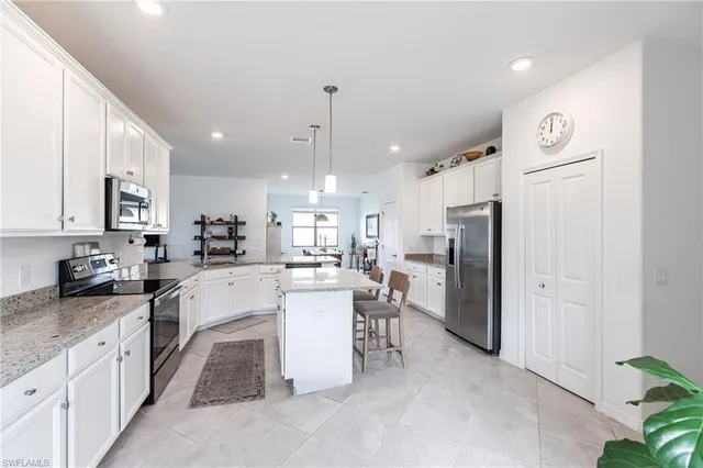 a kitchen with refrigerator and cabinets