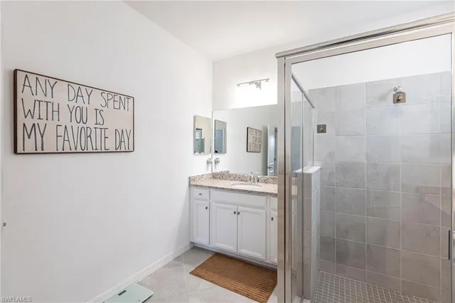 a spacious bathroom with a shower and a sink