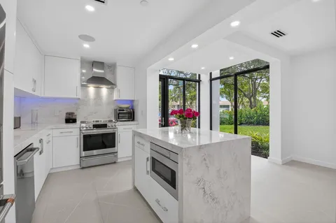 a kitchen with sink a stove and refrigerator