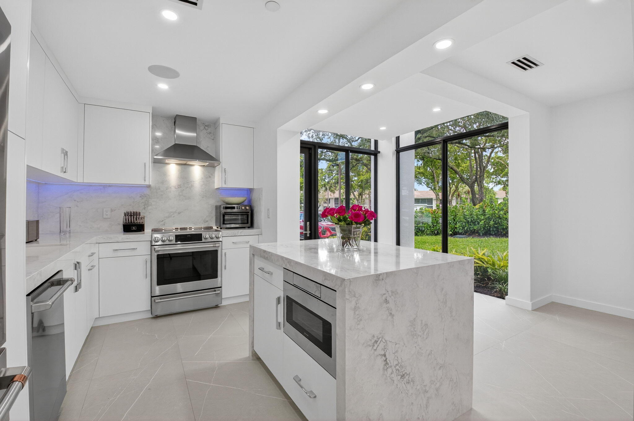 a kitchen with sink a stove and refrigerator