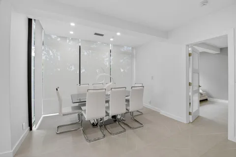 a view of a dining room with furniture wooden floor and a floor to ceiling window