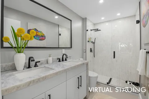 a bedroom with a large bed and a balcony next to a window