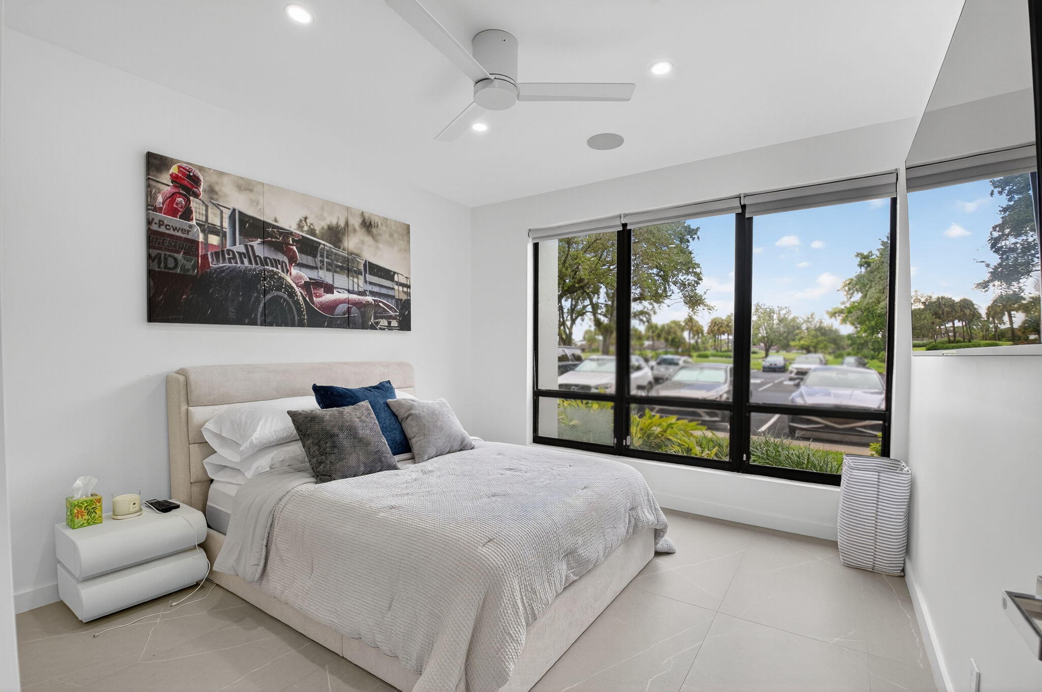 7847 Lakeside Boulevard, Unit 1014 Boca Raton, FL 33434 - Photo 26 of 53 a bedroom with a bed and a large window