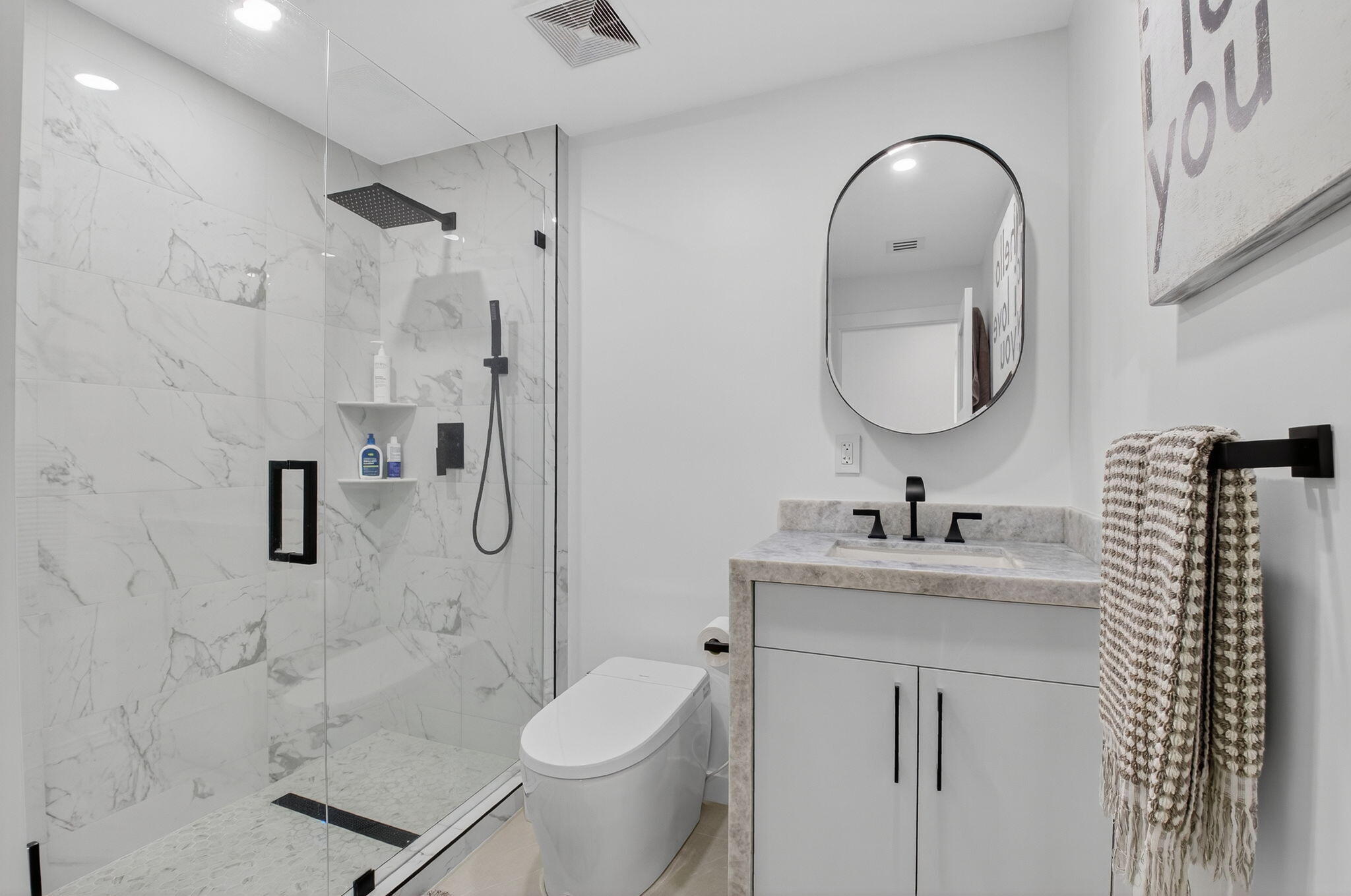 7847 Lakeside Boulevard, Unit 1014 Boca Raton, FL 33434 - Photo 28 of 53 a bathroom with a sink toilet and shower
