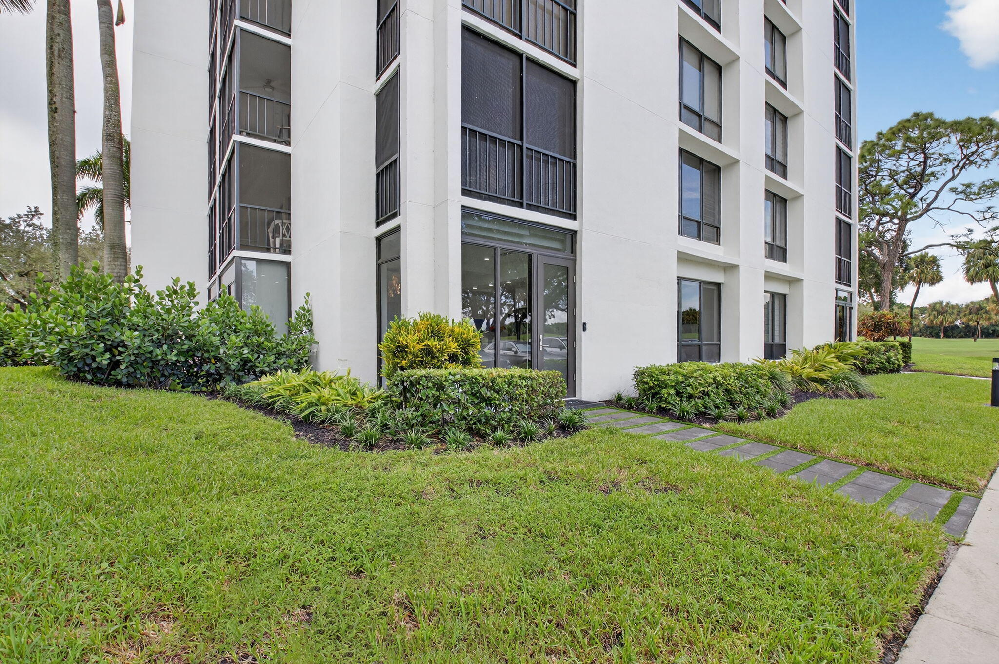 7847 Lakeside Boulevard, Unit 1014 Boca Raton, FL 33434 - Photo 30 of 53 a view of a building with garden and entryway