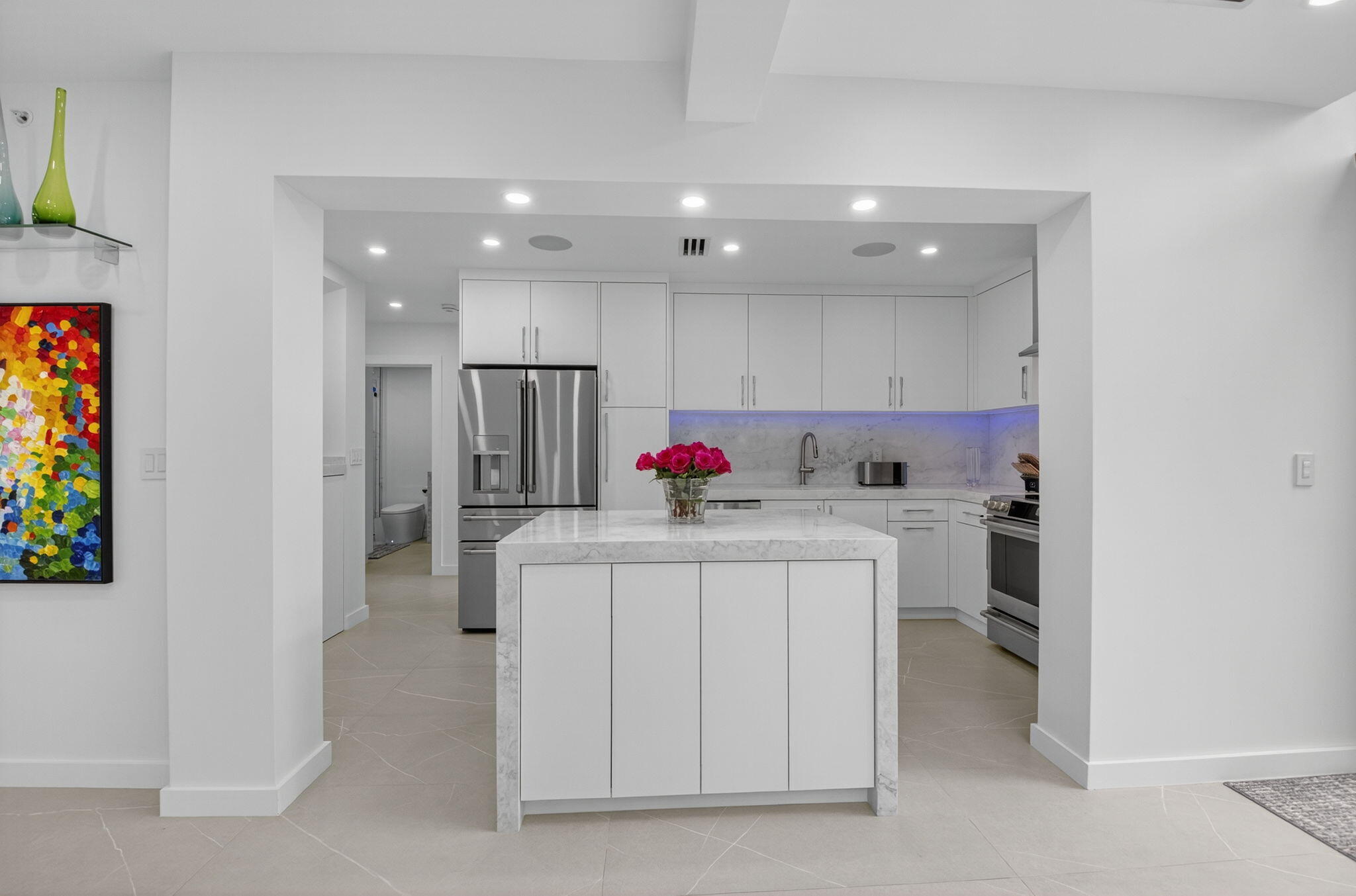 7847 Lakeside Boulevard, Unit 1014 Boca Raton, FL 33434 - Photo 5 of 53 a kitchen with stainless steel appliances granite countertop a white cabinets and a refrigerator