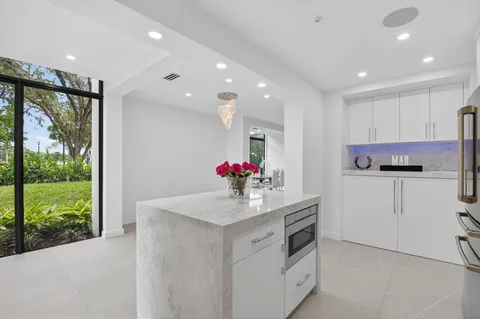 a kitchen with kitchen island a sink stainless steel appliances and cabinets