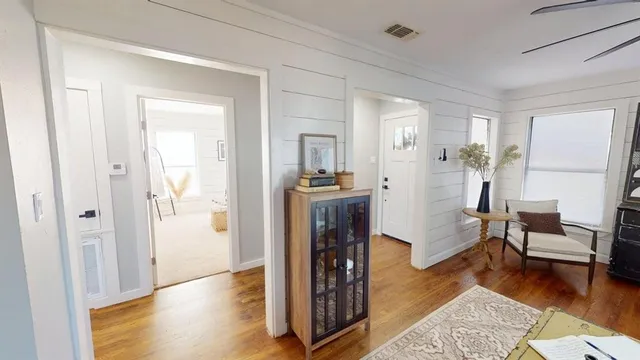 a view of a livingroom with furniture and hardwood floor