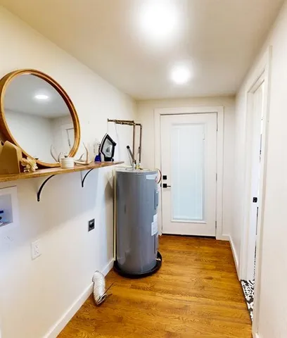 a view of a room with wooden floor and white walls
