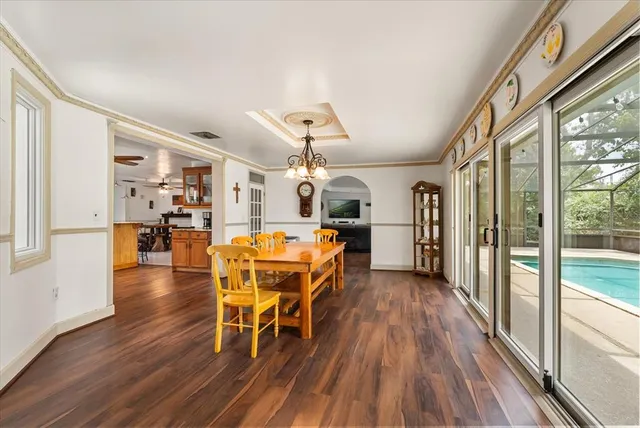 a dining room with furniture and wooden floor