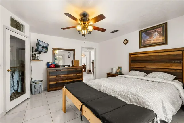 a bedroom with a bed and a chandelier