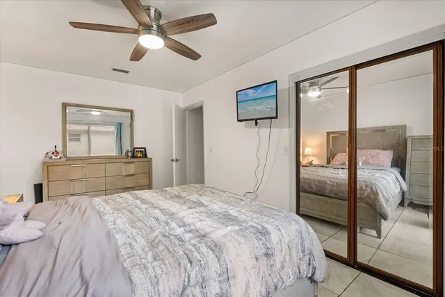a bedroom with a large bed and a chandelier