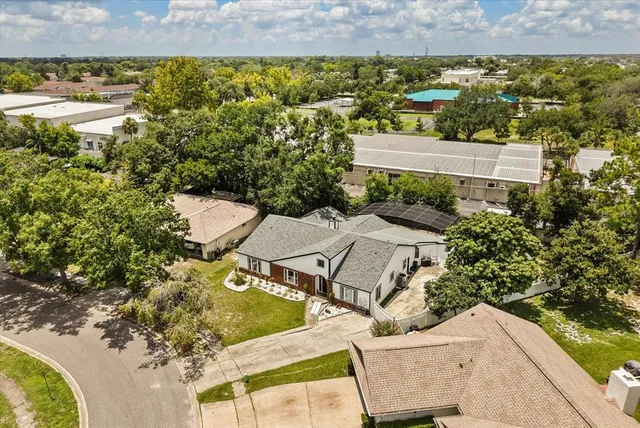 an aerial view of a house with a yard