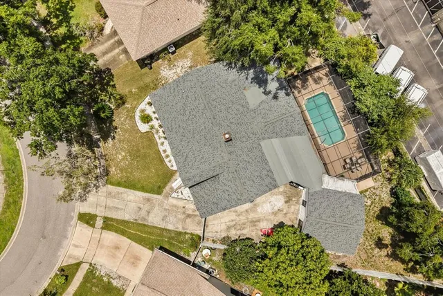 an aerial view of a house with a yard and wooden fence