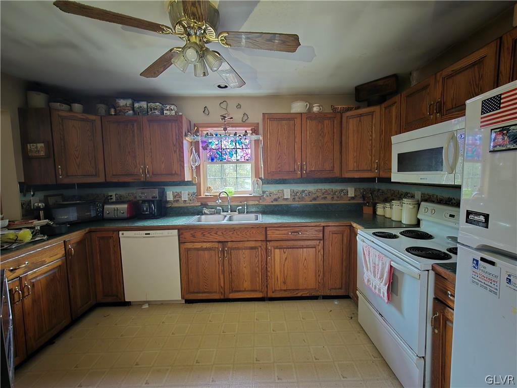 21 Ash Lane Andreas, PA 18211 - Photo 8 of 13 a kitchen with stainless steel appliances granite countertop a stove sink microwave and cabinets