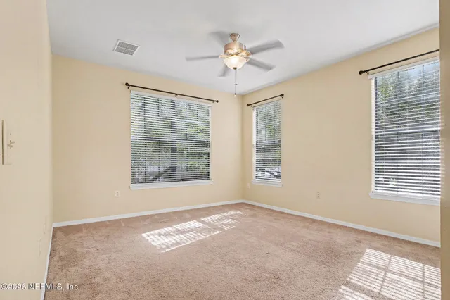 a view of a livingroom with a ceiling fan and window