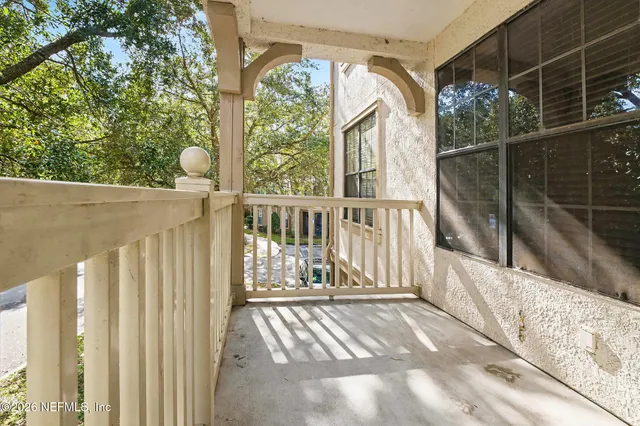 a view of a balcony with wooden floor