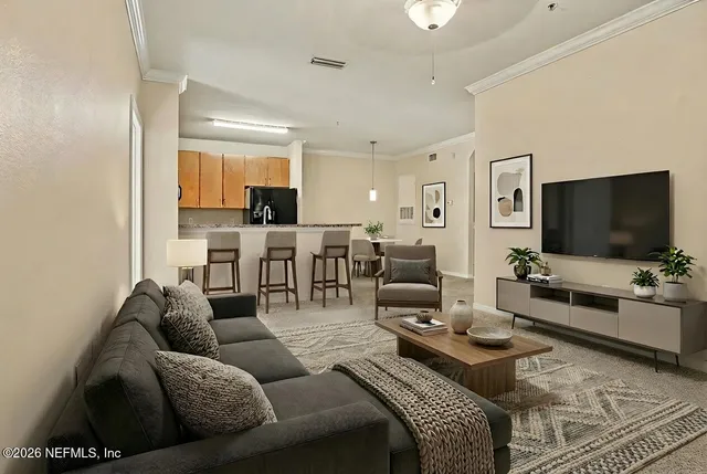 a living room with furniture and a flat screen tv