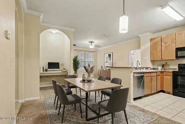 a view of kitchen with sink dining table and chairs