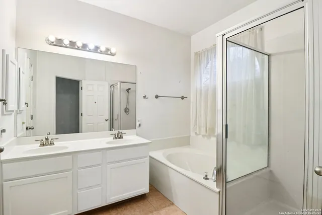 an empty room with chandelier fan and windows