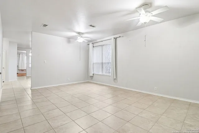 an empty room with fan and a ceiling fan