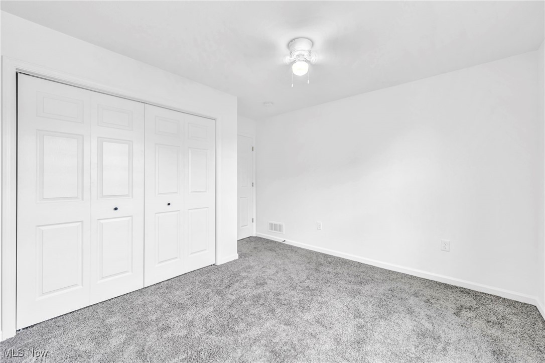 3709 Sudbury Road Cleveland, OH 44120 - Photo 23 of 29 Unfurnished bedroom with a closet, ceiling fan, and carpet floors