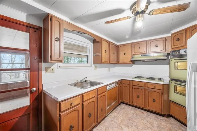a kitchen with stainless steel appliances granite countertop a sink and cabinets