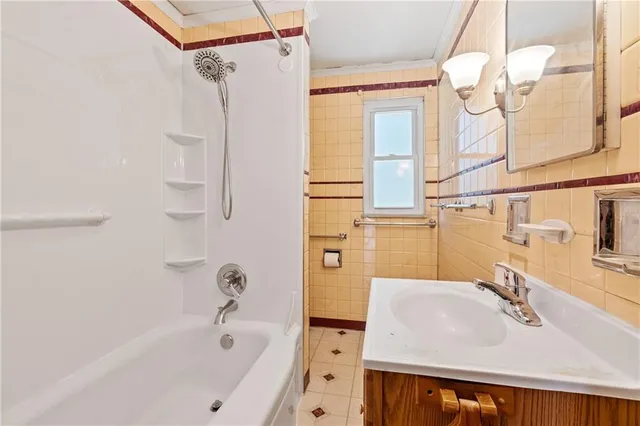 a bathroom with a sink a mirror and a bathtub