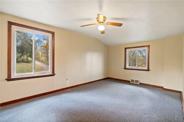 a view of an empty room with windows