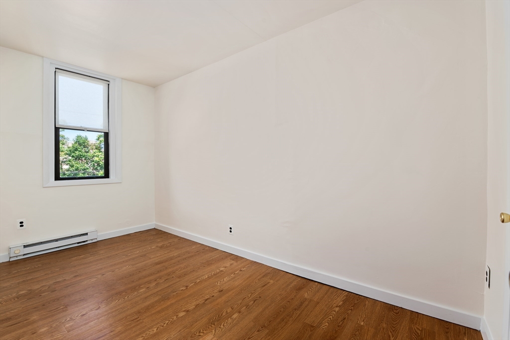 9 Buswell Street, Unit 2R Boston, MA 02215 - Photo 12 of 17 an empty room with a window