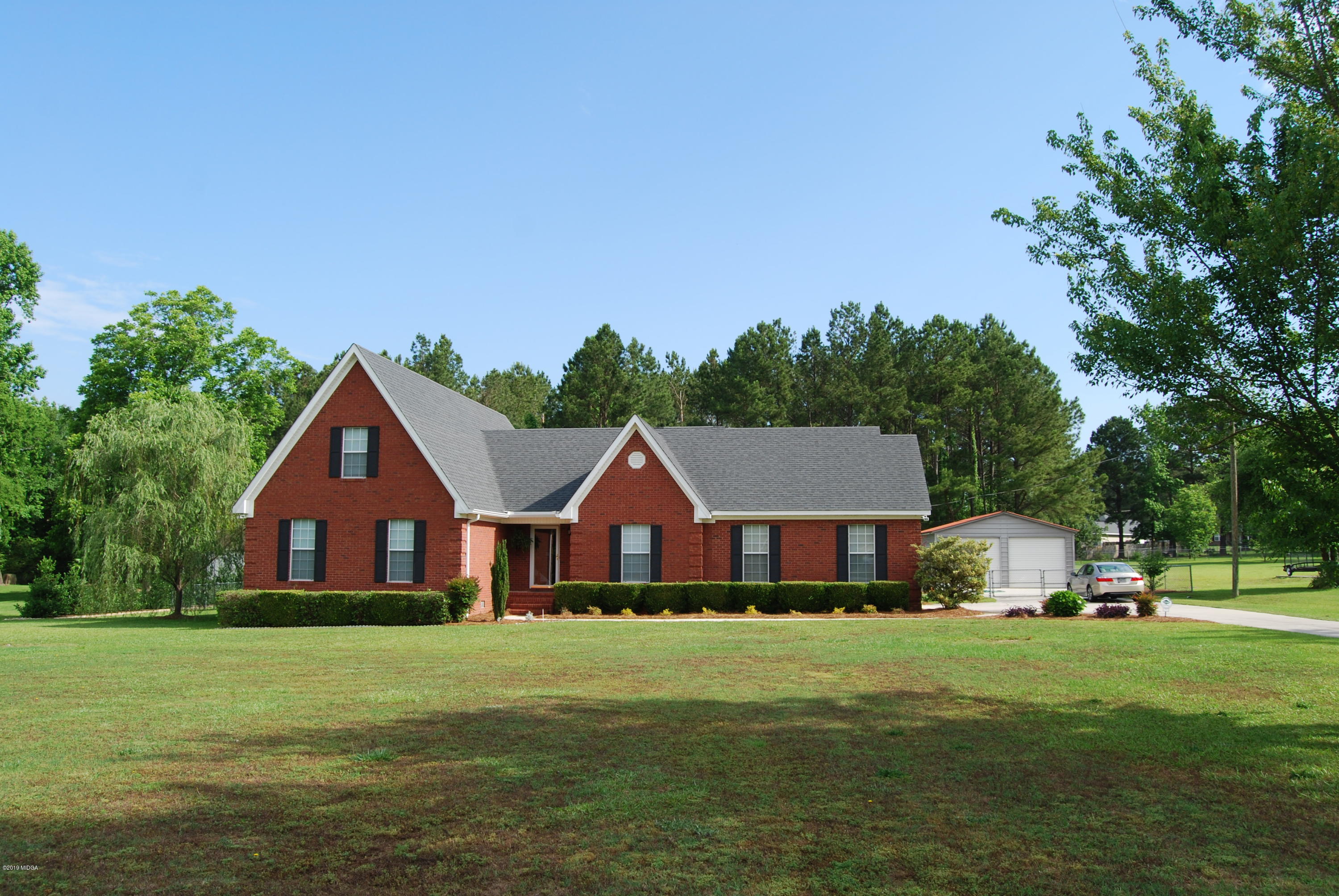 113 Marcar Road Macon, GA 31216 - Photo 1 of 31 a front view of a house with a garden and trees