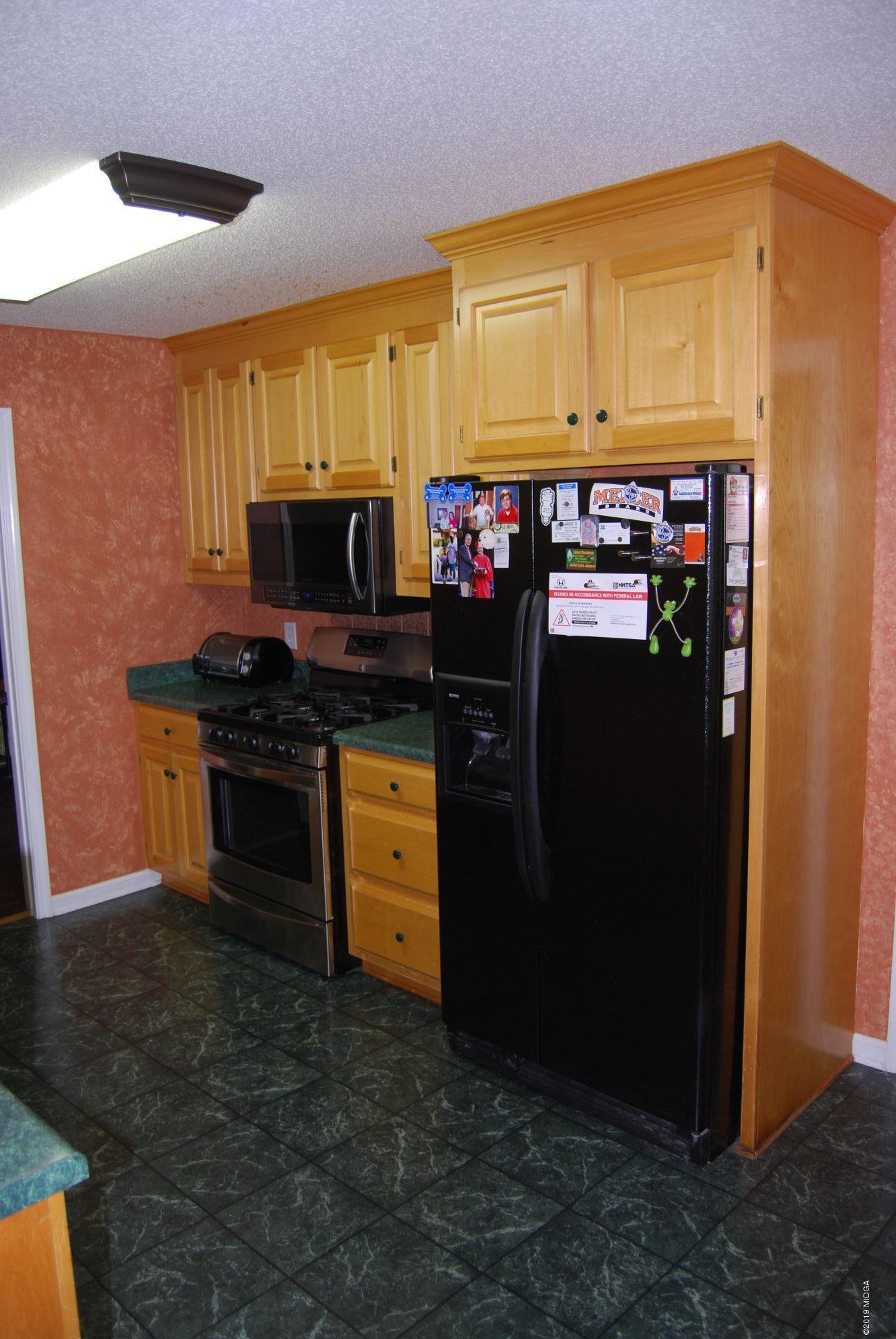 113 Marcar Road Macon, GA 31216 - Photo 2 of 31 a kitchen with stainless steel appliances a stove and a refrigerator