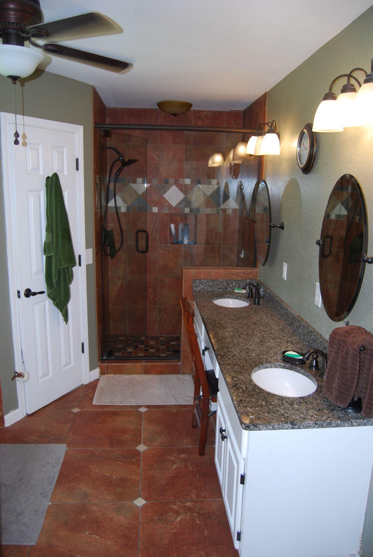 113 Marcar Road Macon, GA 31216 - Photo 11 of 31 a bathroom with a granite countertop sink and a mirror