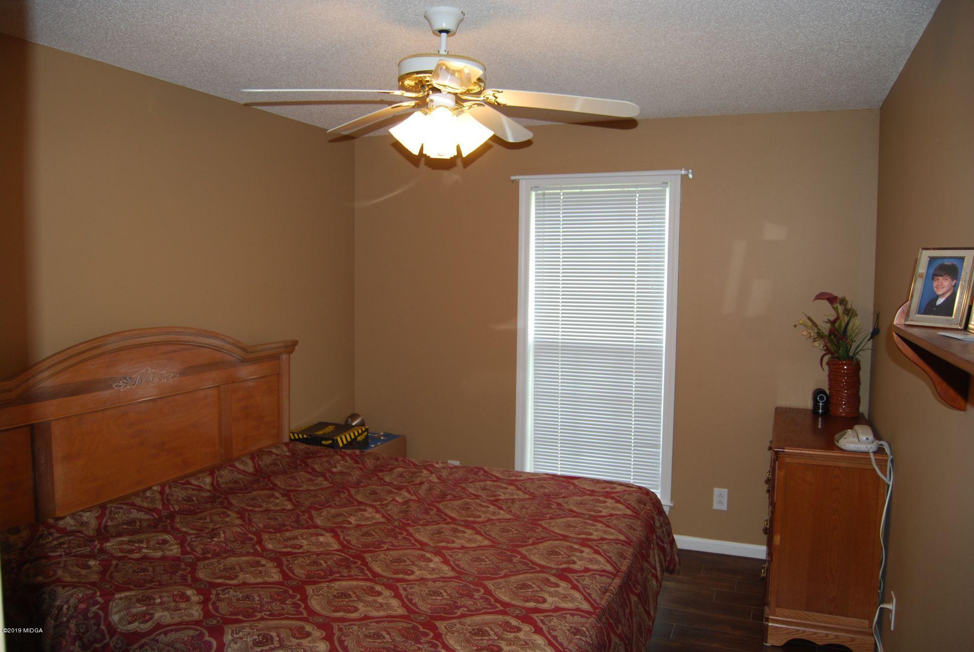 113 Marcar Road Macon, GA 31216 - Photo 12 of 31 a bedroom with a bed and a chandelier
